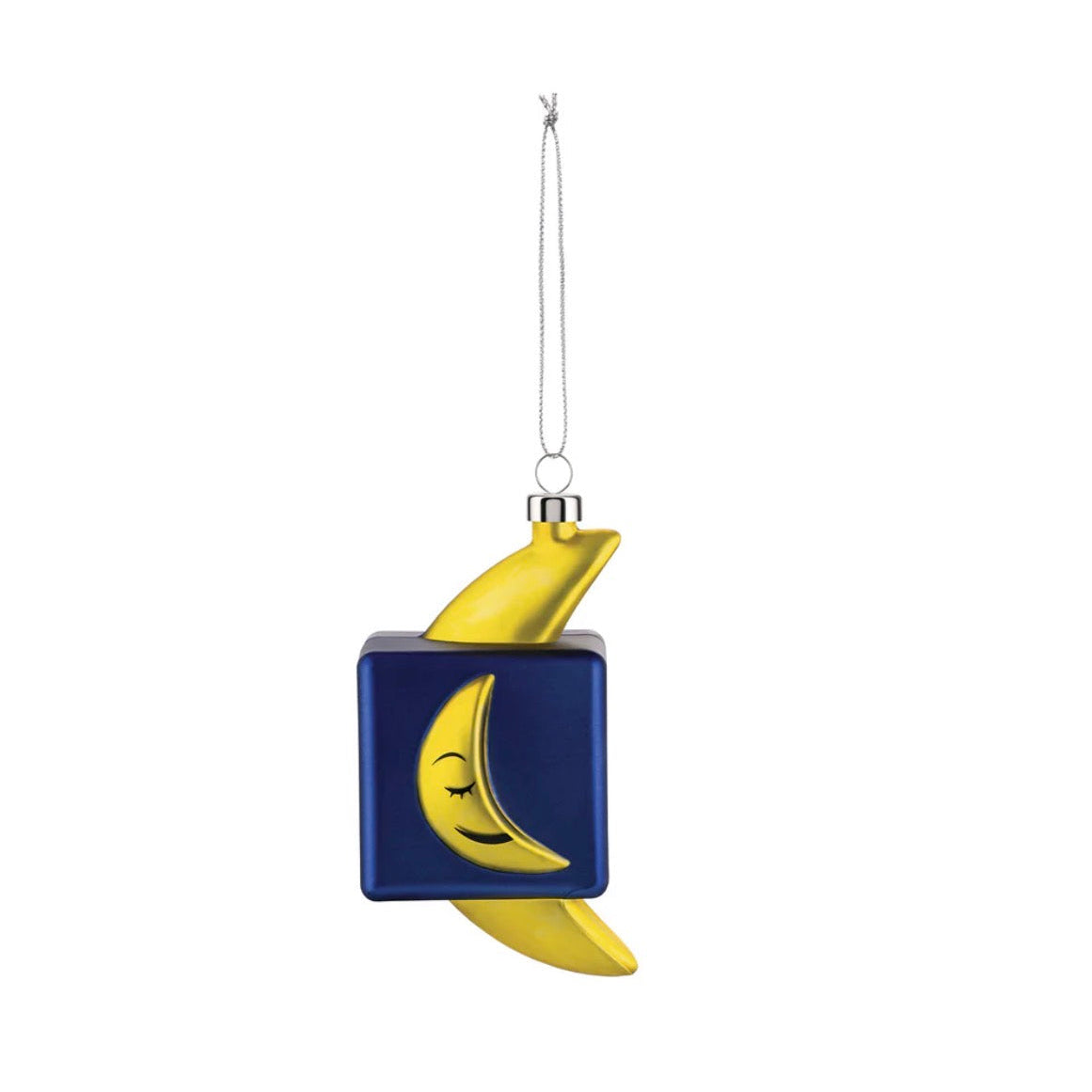 Decorazione Natalizia Mooncube di Alessi. decorazionbe per albero di natale a forma di banana racchiusa in un cubo.  I colori sono giallo e blu